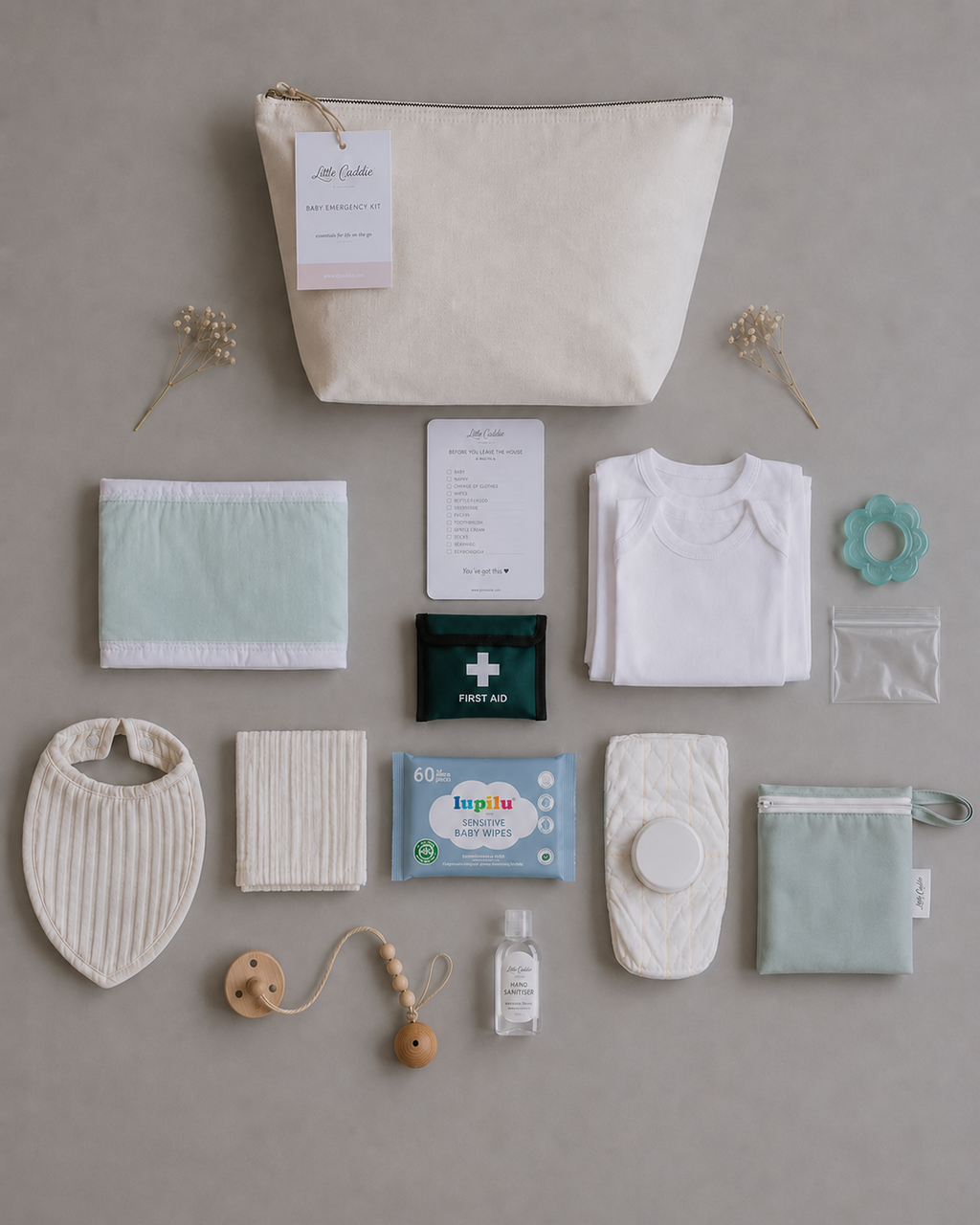 Little Caddie Co Complete Baby Emergency Kit with everyday essentials neatly displayed.