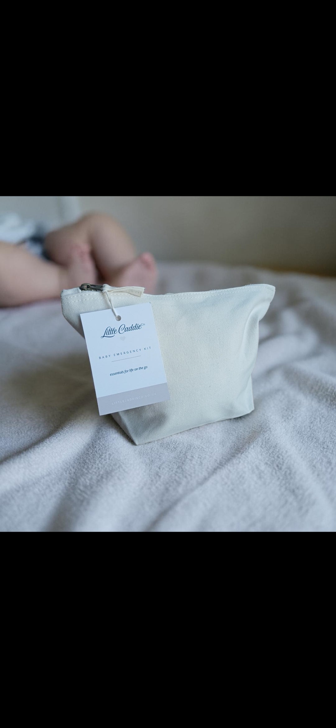 Little Caddie Co baby emergency kit beside a baby, ready for everyday parenting essentials.