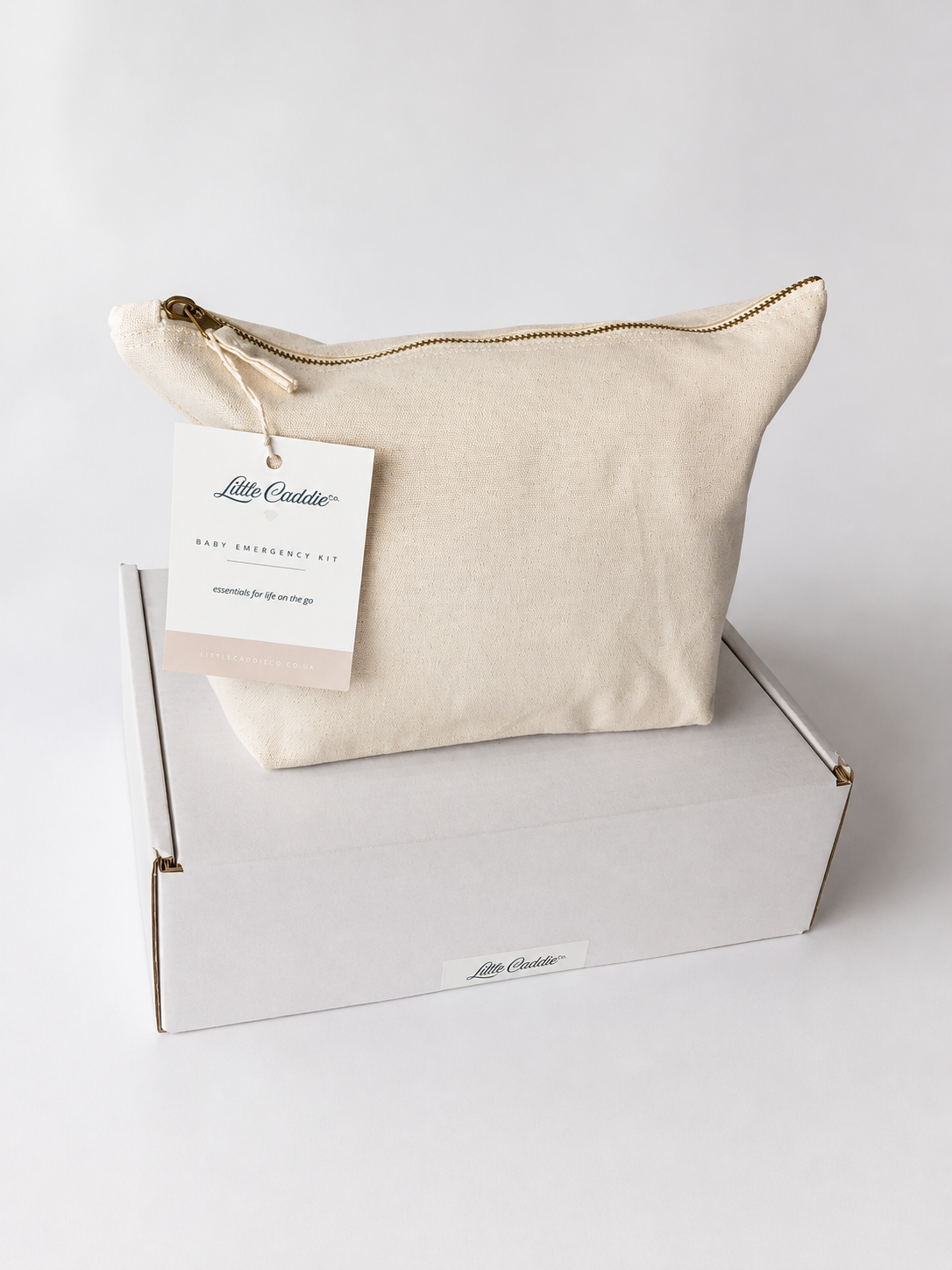 Little Caddie Baby Emergency Kit in a cream canvas zip bag, displayed on its white Top-Up Pack box.