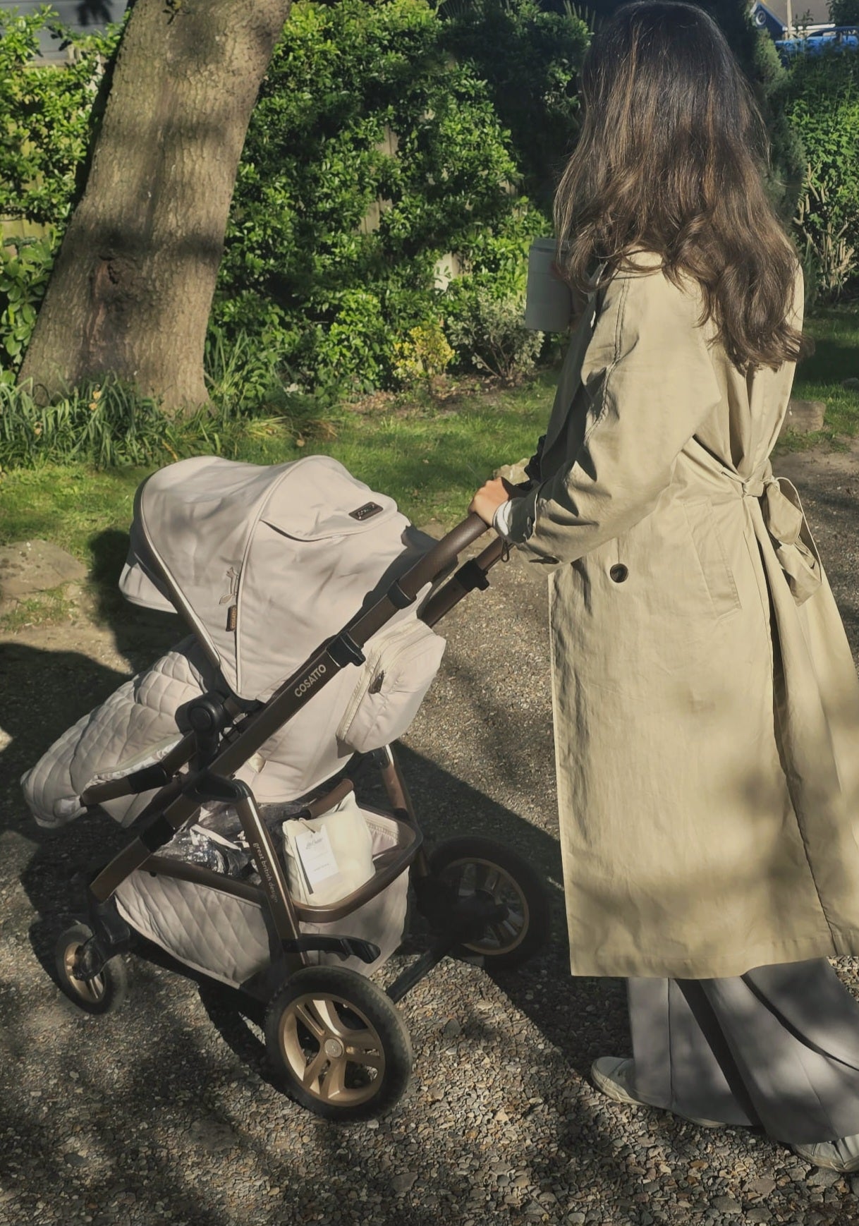 Parent enjoying a walk with a pushchair while carrying a Little Caddie Co baby emergency kit.