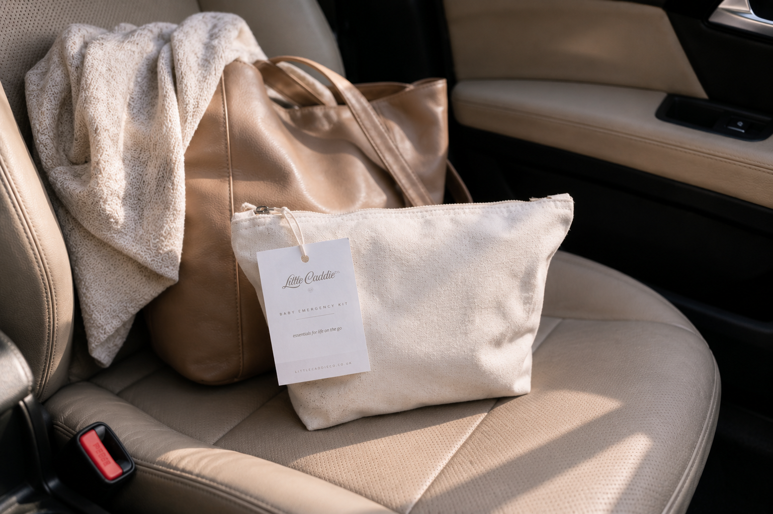 Little Caddie Co Everyday Baby Emergency Kit on a car seat, ready for family journeys and days out.